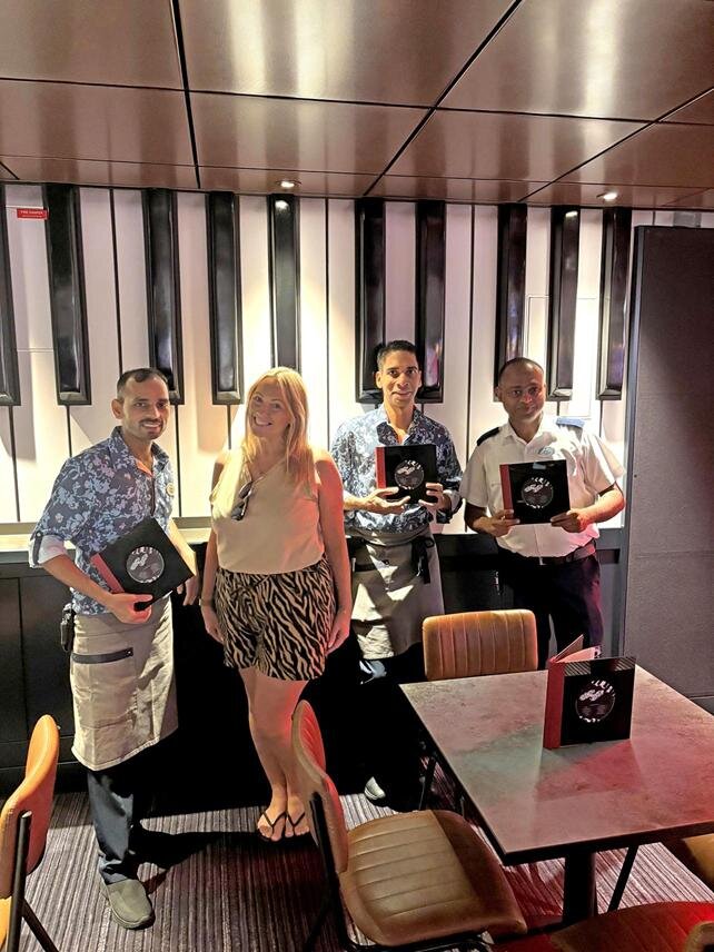 Lavinia Chew from Hays Travel with Duelling Pianos staff on Icon of the Seas