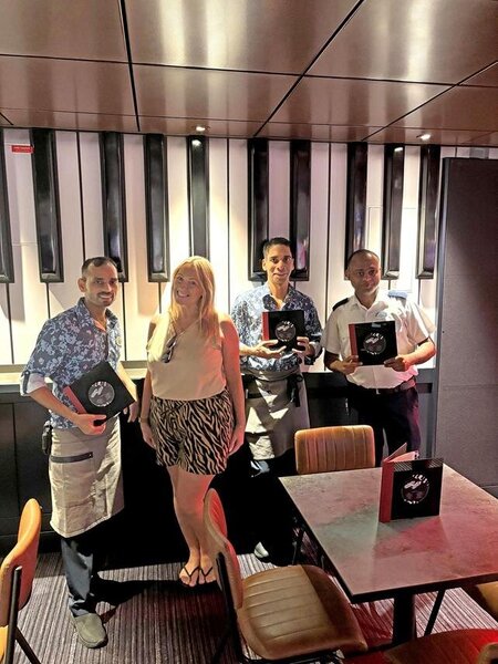 Lavinia Chew from Hays Travel with Duelling Pianos staff on Icon of the Seas