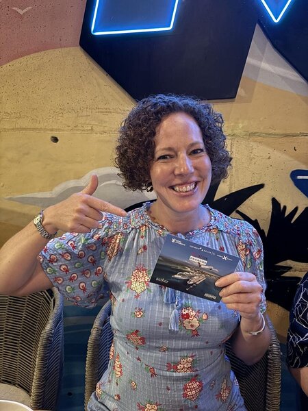 Leanne Rudd with a Destination Unknown points postcard