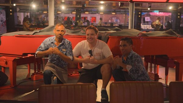 Sam Griffiths from Cruise1st with Duelling Pianos staf on Icon of the Seas