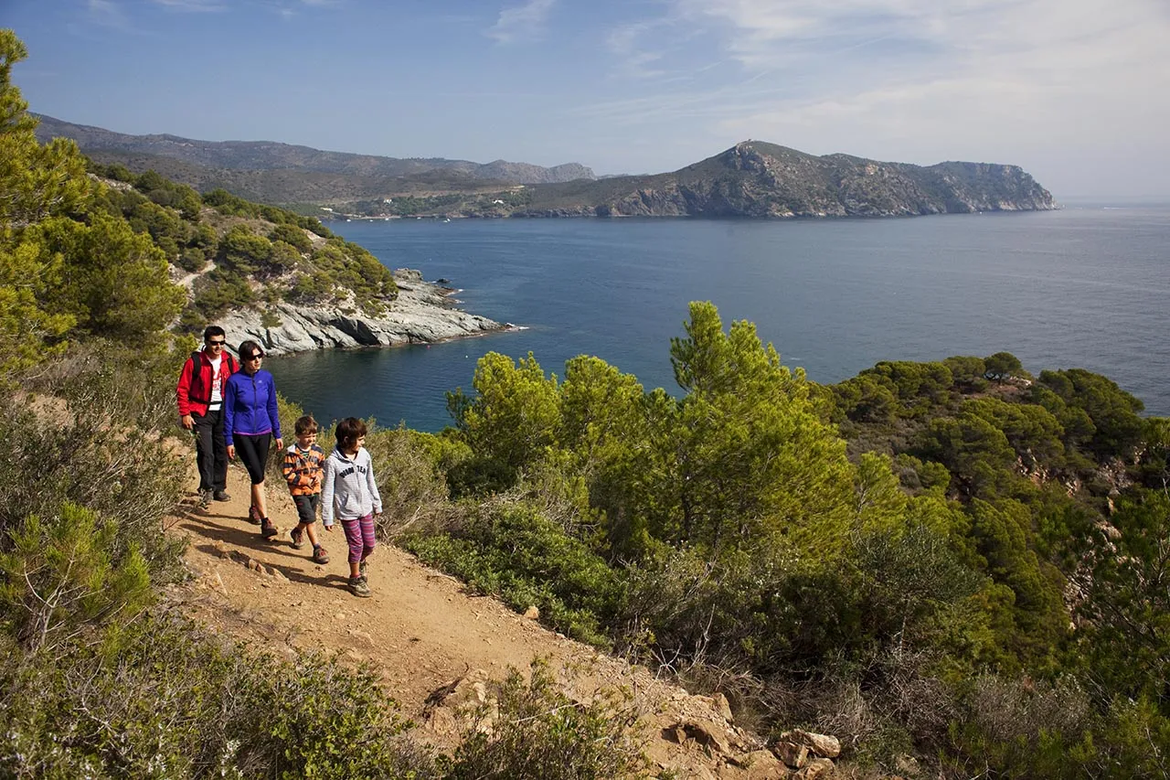 Hikers walking a stretch of the coastal path at Cap de Creus